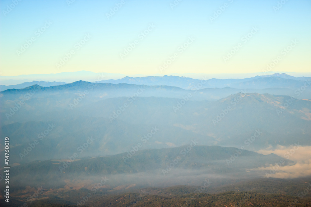 Nature on mountain peaks with mist overlay