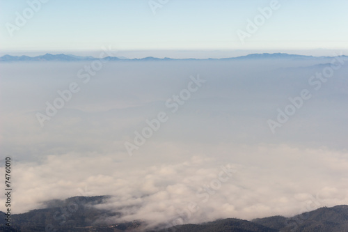 Nature on mountain peaks with mist overlay