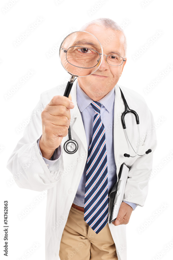 Mature doctor looking through a magnifying glass Mature doctor looking through a magnifying glass