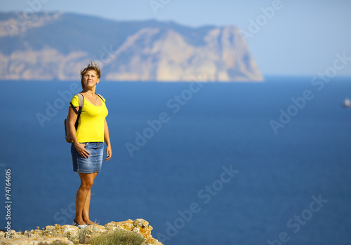 woman on top of a mountain above the sea photo