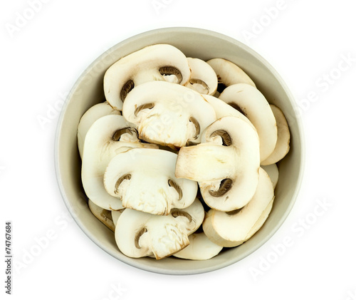 Bowl of juicy sliced mushrooms isolated against white