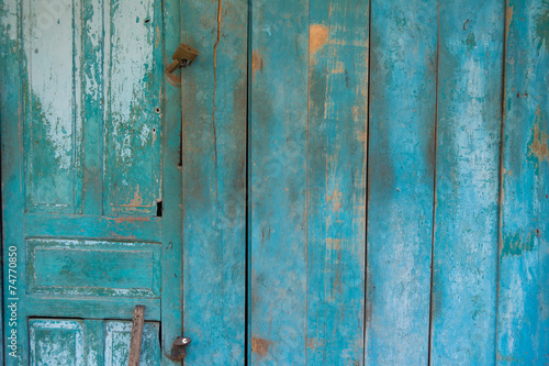 Blue weathered wooden door with rusty lock