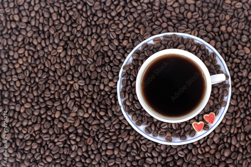 Fototapeta premium cup of coffee with heart on the background of coffee