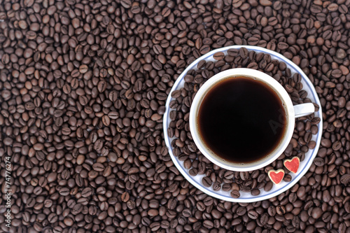 cup of coffee with heart on the background of coffee