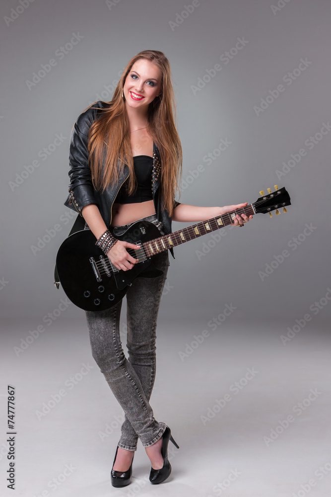 Fototapeta premium Beautiful girl playing guitar