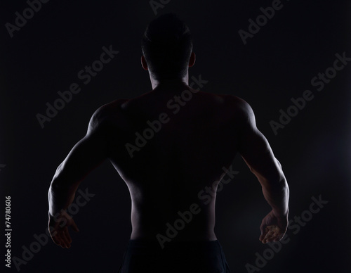 Rear view of healthy muscular young man , silhouette © Drobot Dean