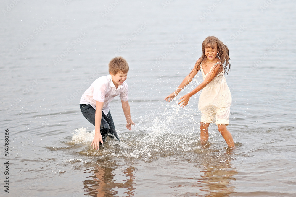 Portrait of a boy and girl playing on the beach Portrait of a boy and girl playing on the beach