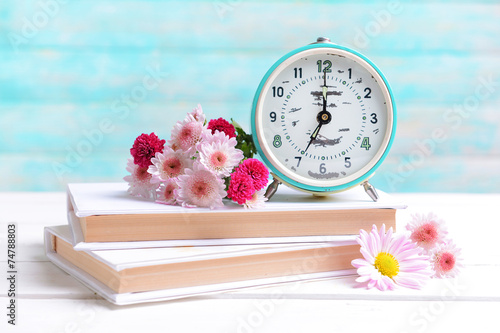 Fototapeta Naklejka Na Ścianę i Meble -  Beautiful flowers with clock and book