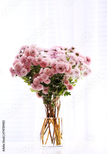 Fototapeta Naklejka Na Ścianę i Meble -  Beautiful flowers in vase with light from window