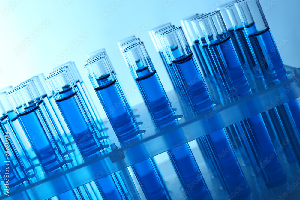 Blue water in a transparent test-tube on light background Blue water in a transparent test-tube on light background