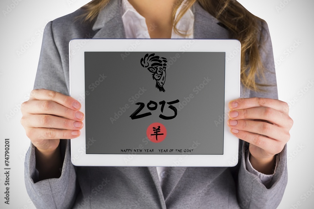 Composite image of businesswoman showing a tablet pc Composite image of businesswoman showing a tablet pc