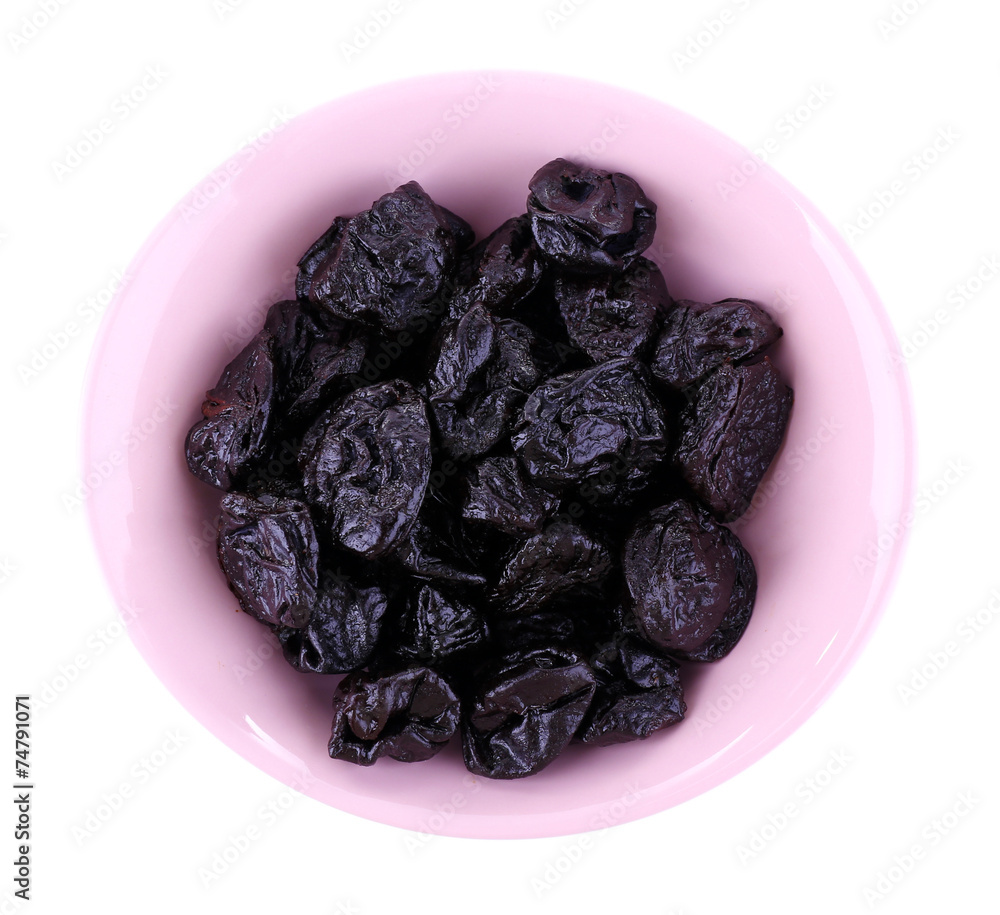 Purple bowl of prunes isolated on white Purple bowl of prunes isolated on white