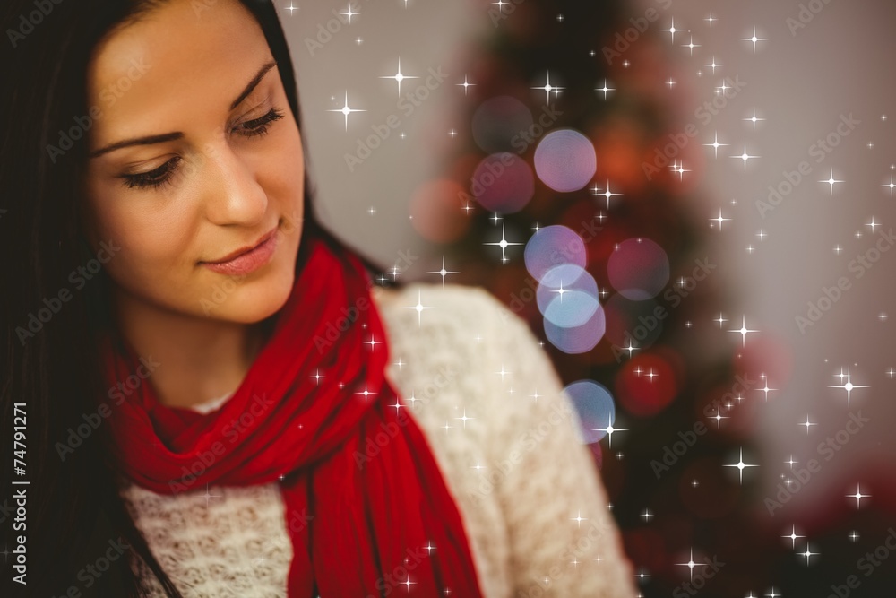 Composite image of pretty brunette relaxing at christmas Composite image of pretty brunette relaxing at christmas