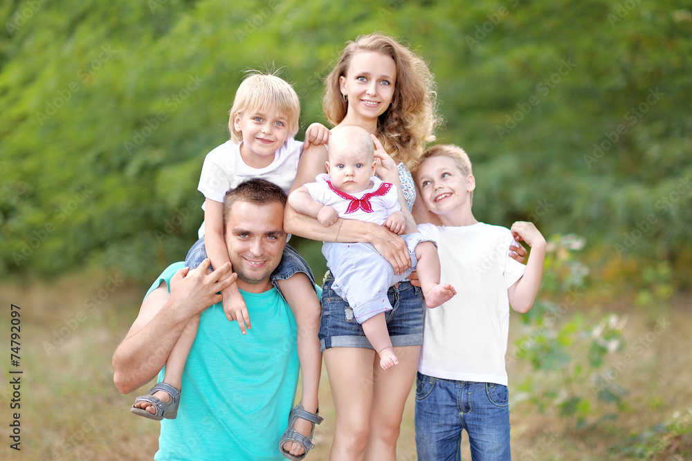 portrait of a happy family on summer nature