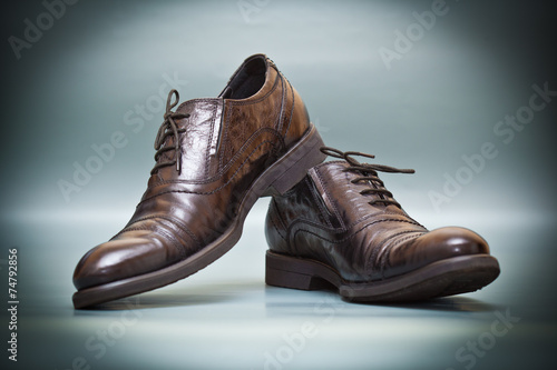 Fashion classic expensive leather shoes on abstract background