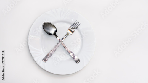 Fork, spoon and white plate
