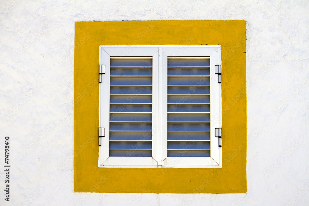 Close up view of a modern aluminum window with a yellow frame. Close up view of a modern aluminum window with a yellow frame.