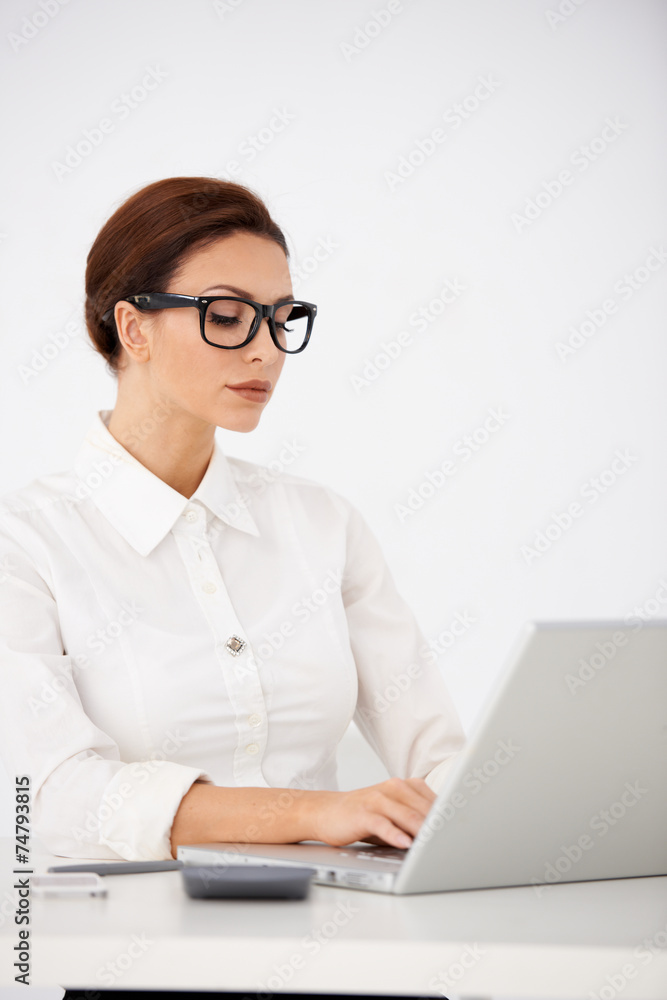 Serious Office Woman Typing on Laptop Serious Office Woman Typing on Laptop
