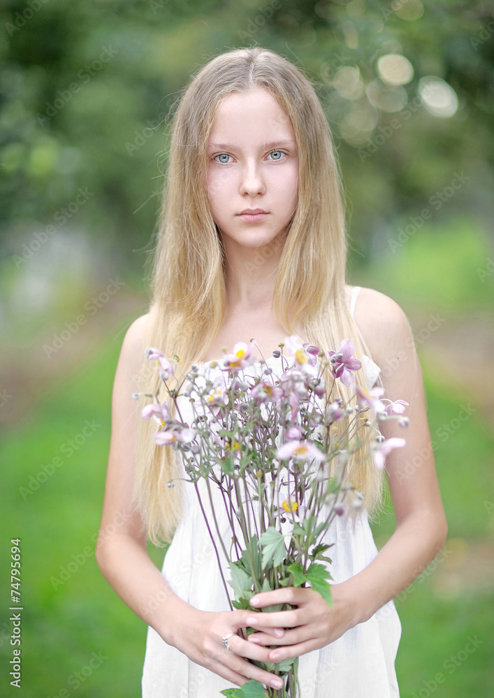 portrait of a beautiful young girl with a bouquet of flowers portrait of a beautiful young girl with a bouquet of flowers