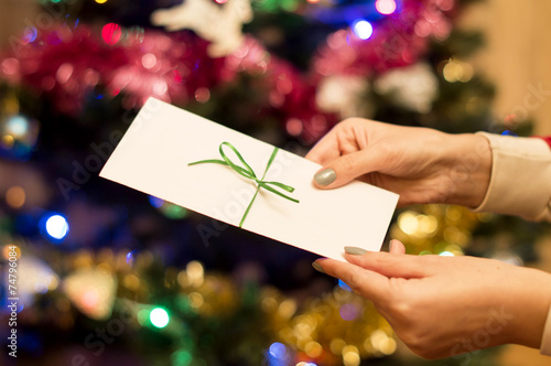 Wallpaper Mural White gift envelope in a female hand with Christmas tree with or Torontodigital.ca