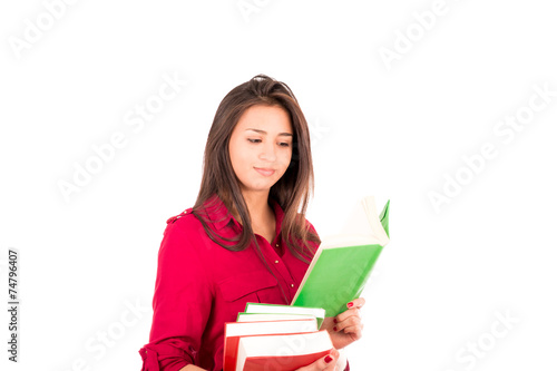 Young Latin Girl Holding stack of books and Reading