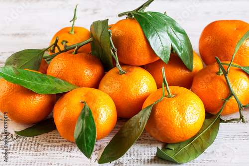 Tangerines with leaves on a wooden table