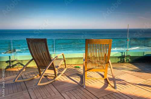 Chairs on a balcony overlooking the Atlantic Ocean at Revel Hote