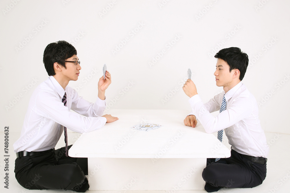 Fototapeta premium 스튜디오 안에서 카드 게임 하는 비즈니스 맨