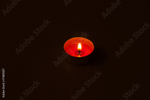 Alone candle in dark