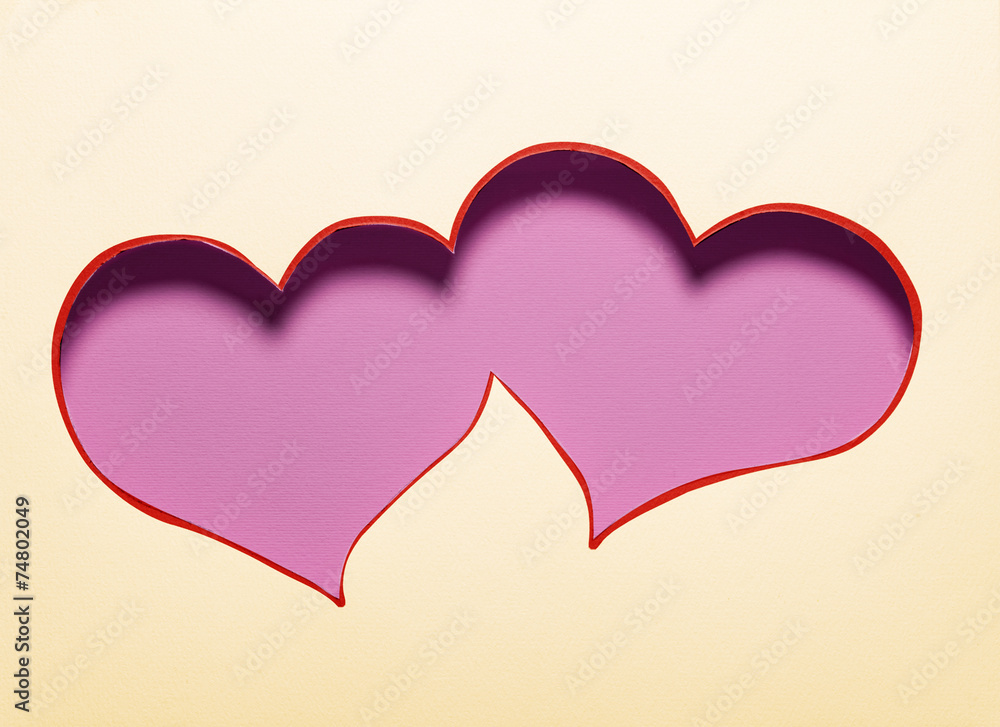 Two hearts cutout in paper.