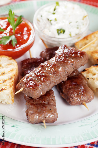 Kebab, meat skewer with tomato and cream sauce