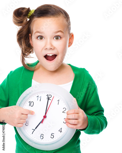 Cute girl is holding big clock