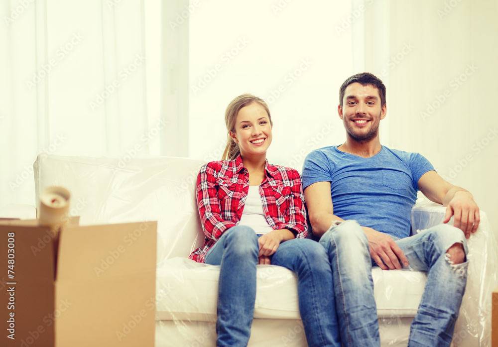 smiling couple relaxing on sofa in new home smiling couple relaxing on sofa in new home