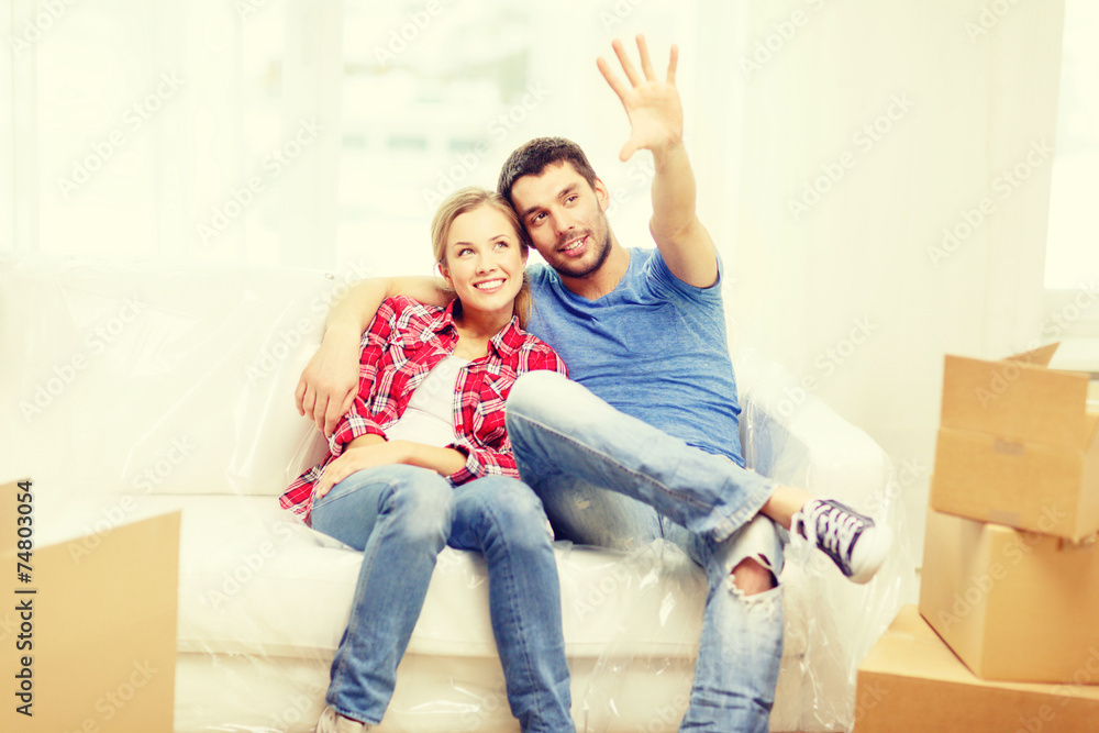 smiling couple relaxing on sofa in new home smiling couple relaxing on sofa in new home
