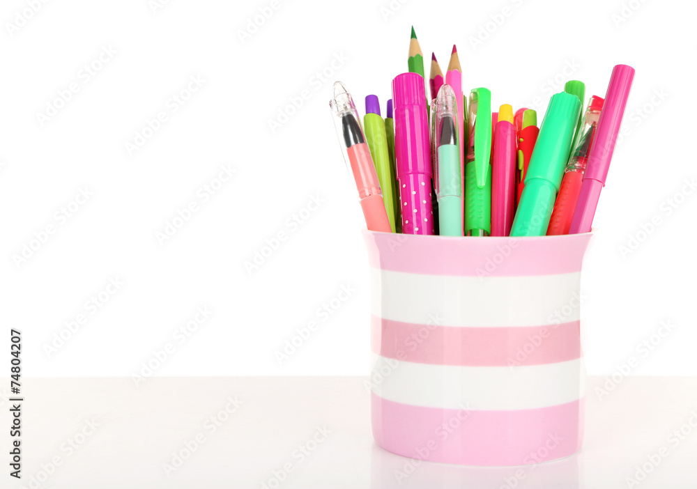 Fototapeta premium Colorful pens,pencils and markers in striped plastic cup