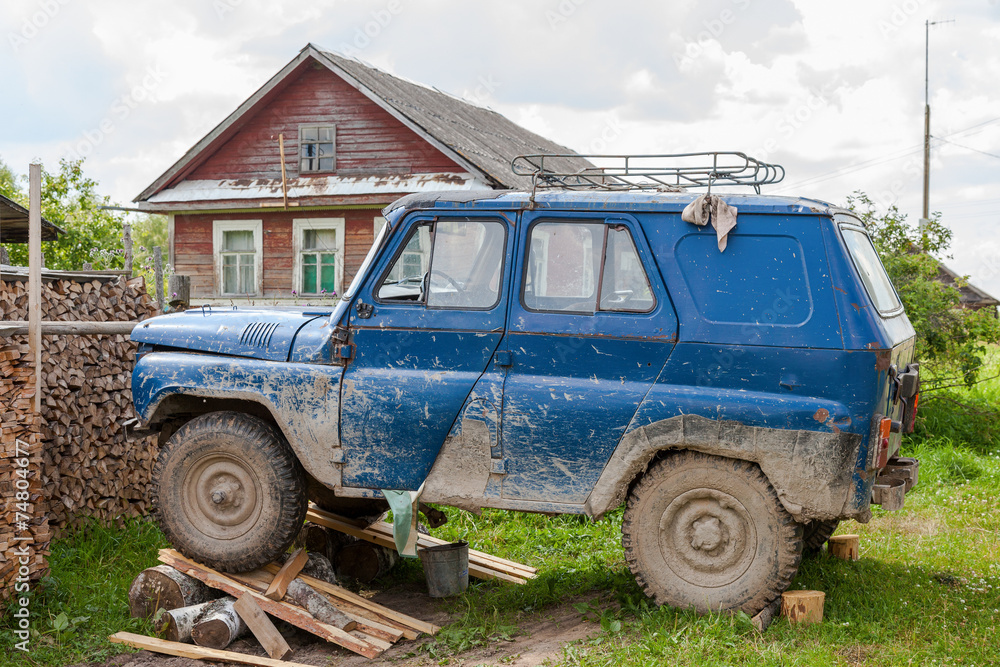 Old, dirty car repaired in a village