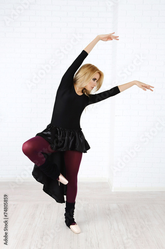Fototapeta Naklejka Na Ścianę i Meble -  Beautiful young ballerina on wall background