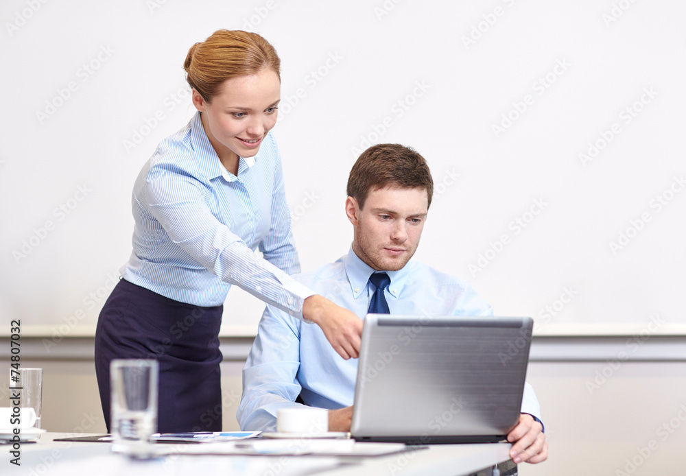 businessman and secretary with laptop in office businessman and secretary with laptop in office