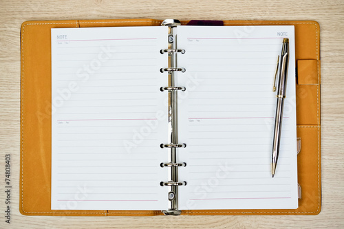 Wallpaper Mural notebook with a pen on wood background Torontodigital.ca