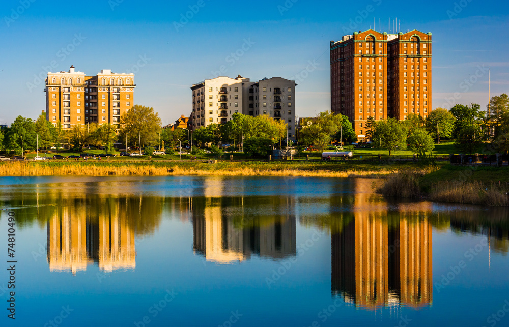 Reflections of buildings in Druid Lake, at Druid Hill Park, in B