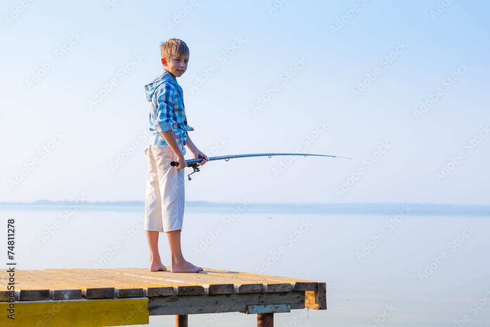 Boy in blue shirt standing on a pie Boy in blue shirt standing on a pie
