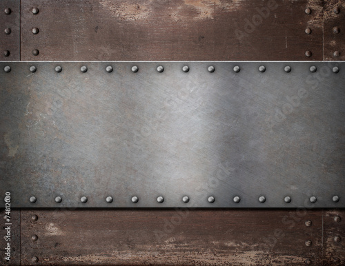 metal plate with rivets over rustic steel background