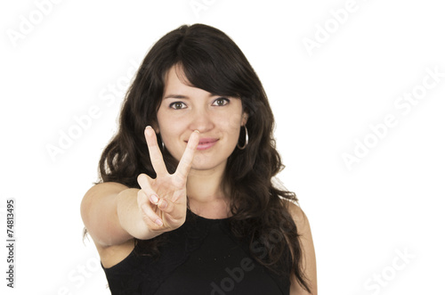 beautiful young brunette woman with black top gesturing peace