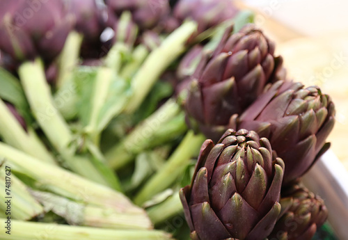 beautiful green artichokes for sale in stand of greengrocers