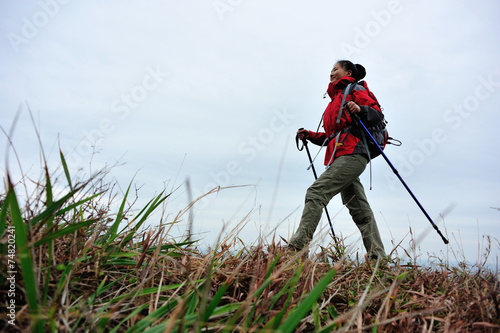 woman hiker hiking on seaside trail 