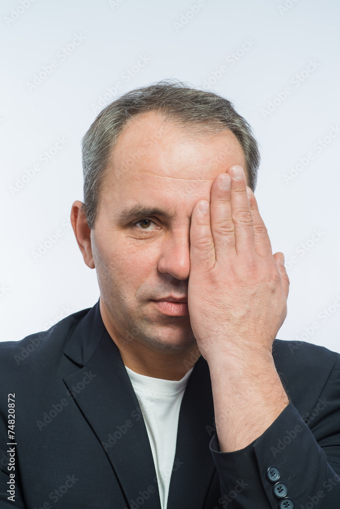 Businessman covering his face with both hands Businessman covering his face with both hands