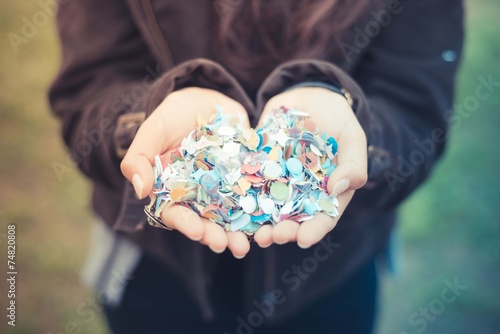 close up of woman hands with confetti