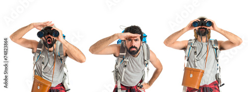 backpacker focusing with his fingers on a white background
