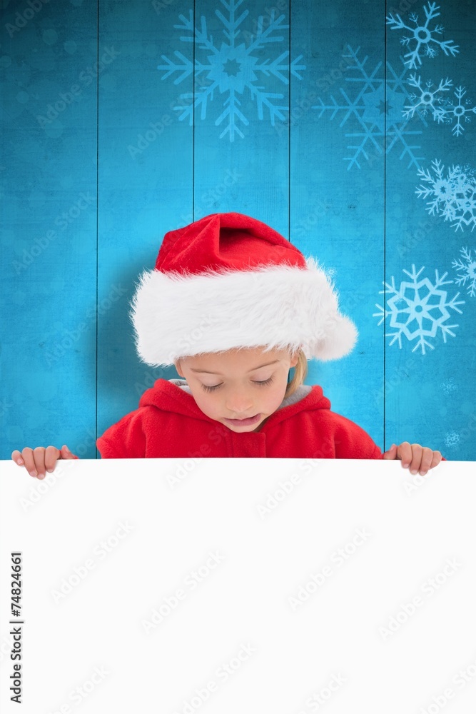 Composite image of festive little girl showing poster Composite image of festive little girl showing poster