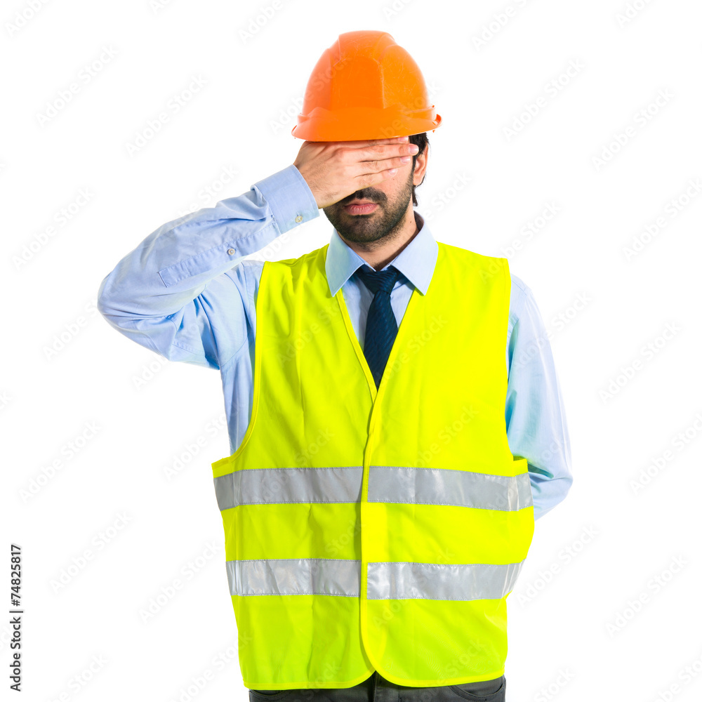 Worker covering his eyes